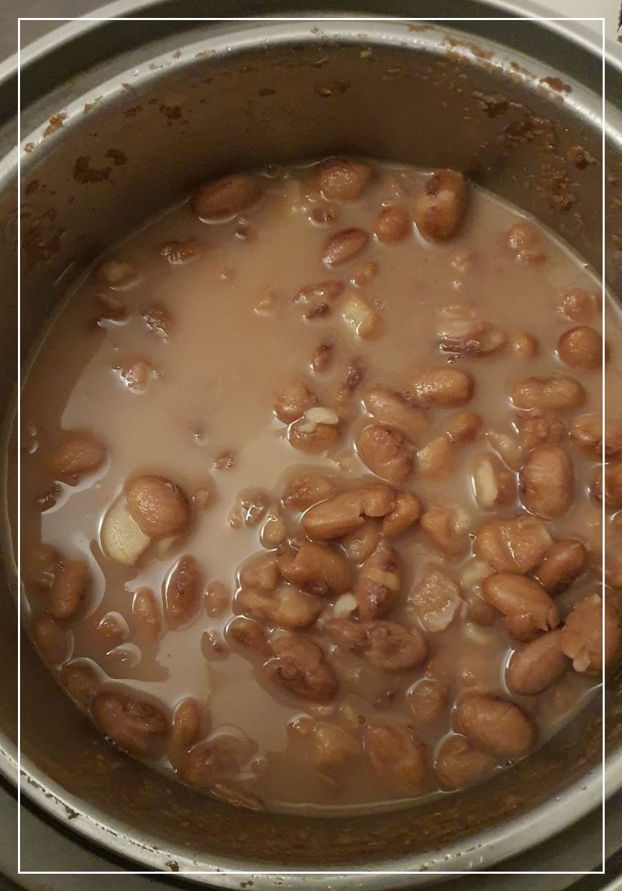 top down view into a pot of cooked pinto beans